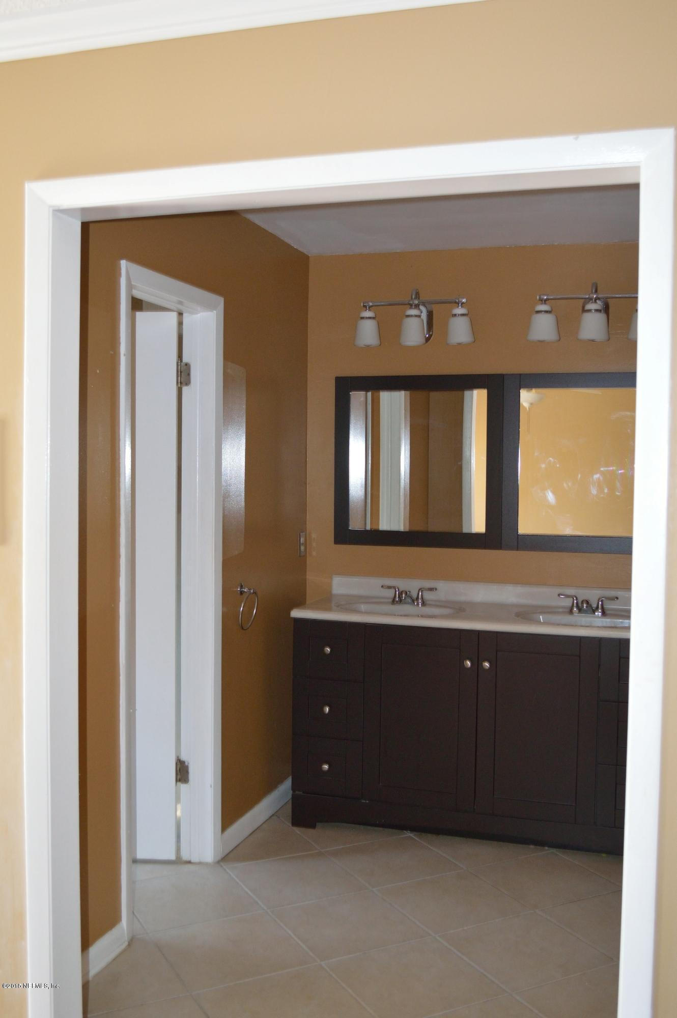 11468 Scott Mill Road Jacksonville, FL 32223 - Photo 19 of 25 a bathroom with a sink and a mirror