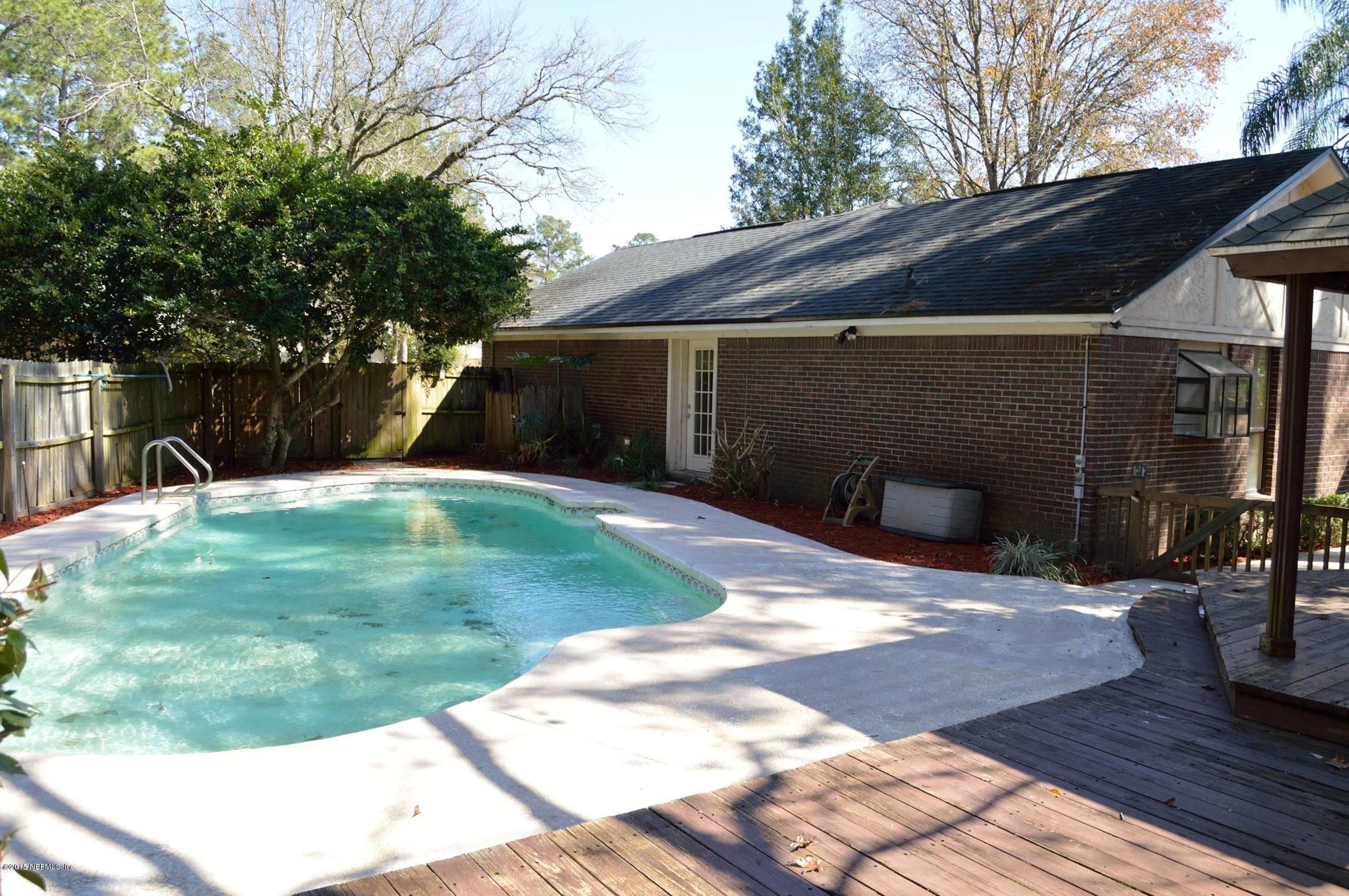 11468 Scott Mill Road Jacksonville, FL 32223 - Photo 21 of 25 a backyard of a house with seating space