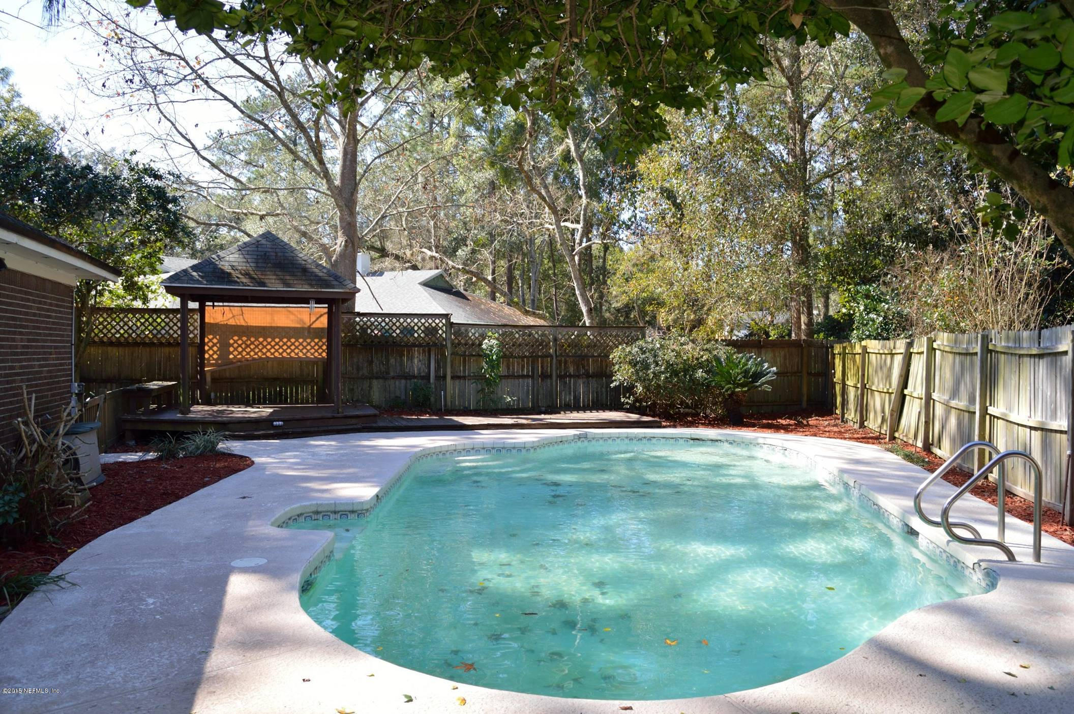 11468 Scott Mill Road Jacksonville, FL 32223 - Photo 23 of 25 a backyard of a house with yard and outdoor seating