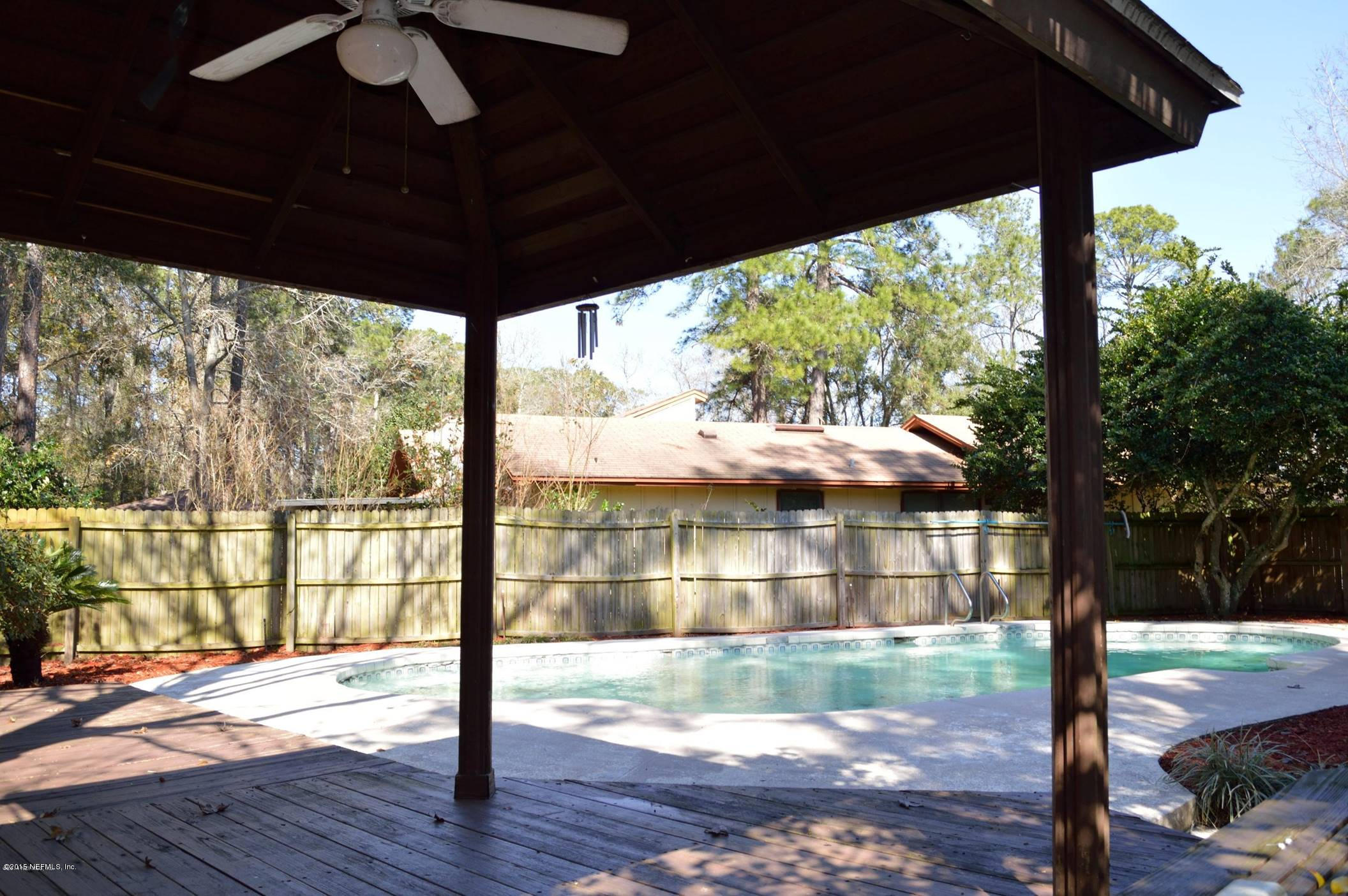 11468 Scott Mill Road Jacksonville, FL 32223 - Photo 24 of 25 a view of empty room with wooden floor and outdoor seating