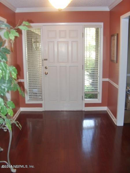 11468 Scott Mill Road Jacksonville, FL 32223 - Photo 4 of 25 a view of an empty room with wooden floor and a window