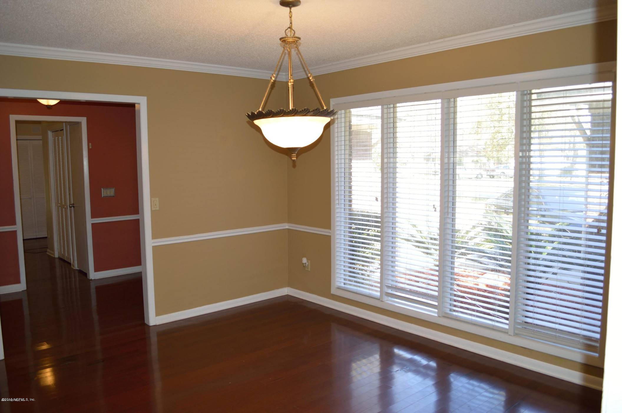 11468 Scott Mill Road Jacksonville, FL 32223 - Photo 6 of 25 a view of a room with a large window and wooden floor