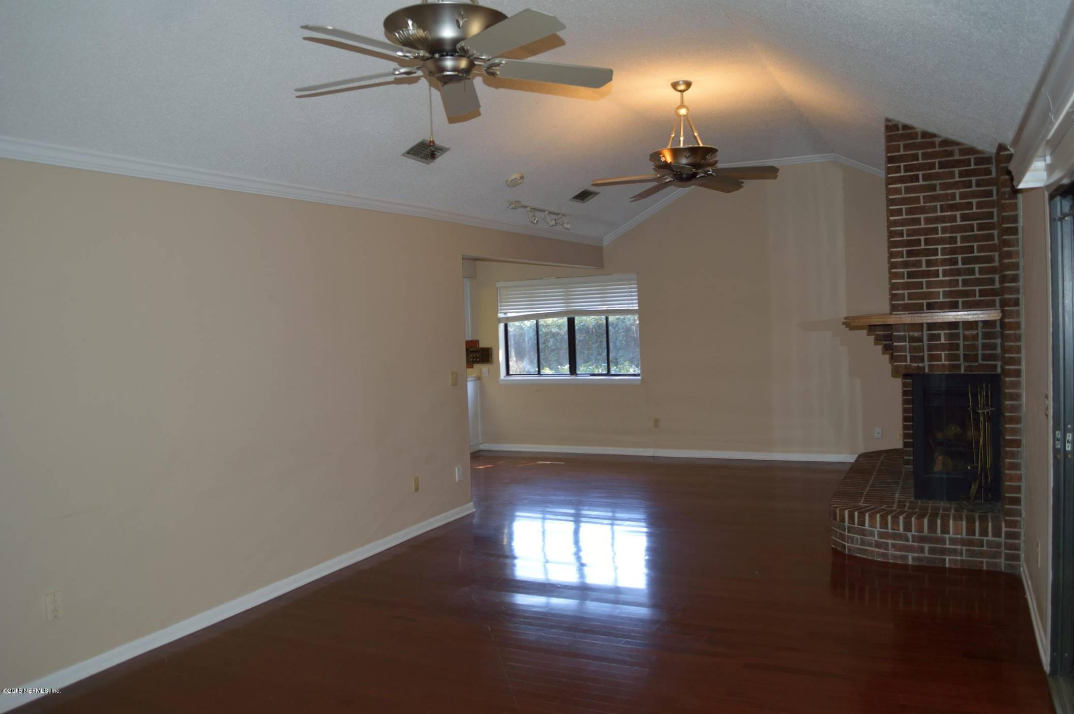 11468 Scott Mill Road Jacksonville, FL 32223 - Photo 7 of 25 wooden floor in an empty room with a window