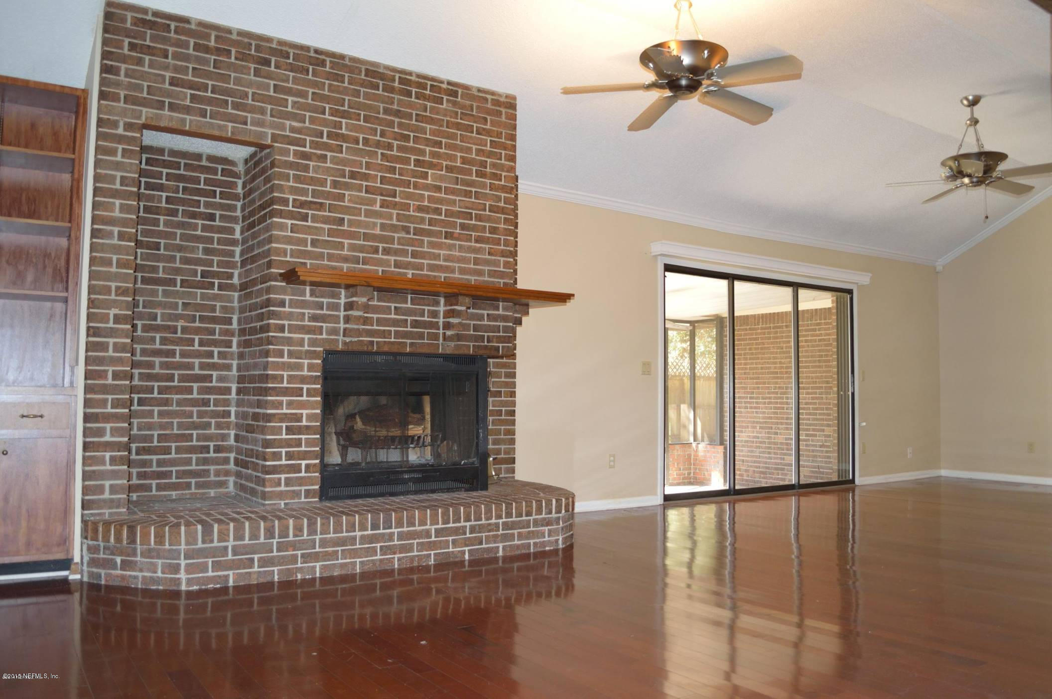 11468 Scott Mill Road Jacksonville, FL 32223 - Photo 9 of 25 a living room with furniture and a fireplace