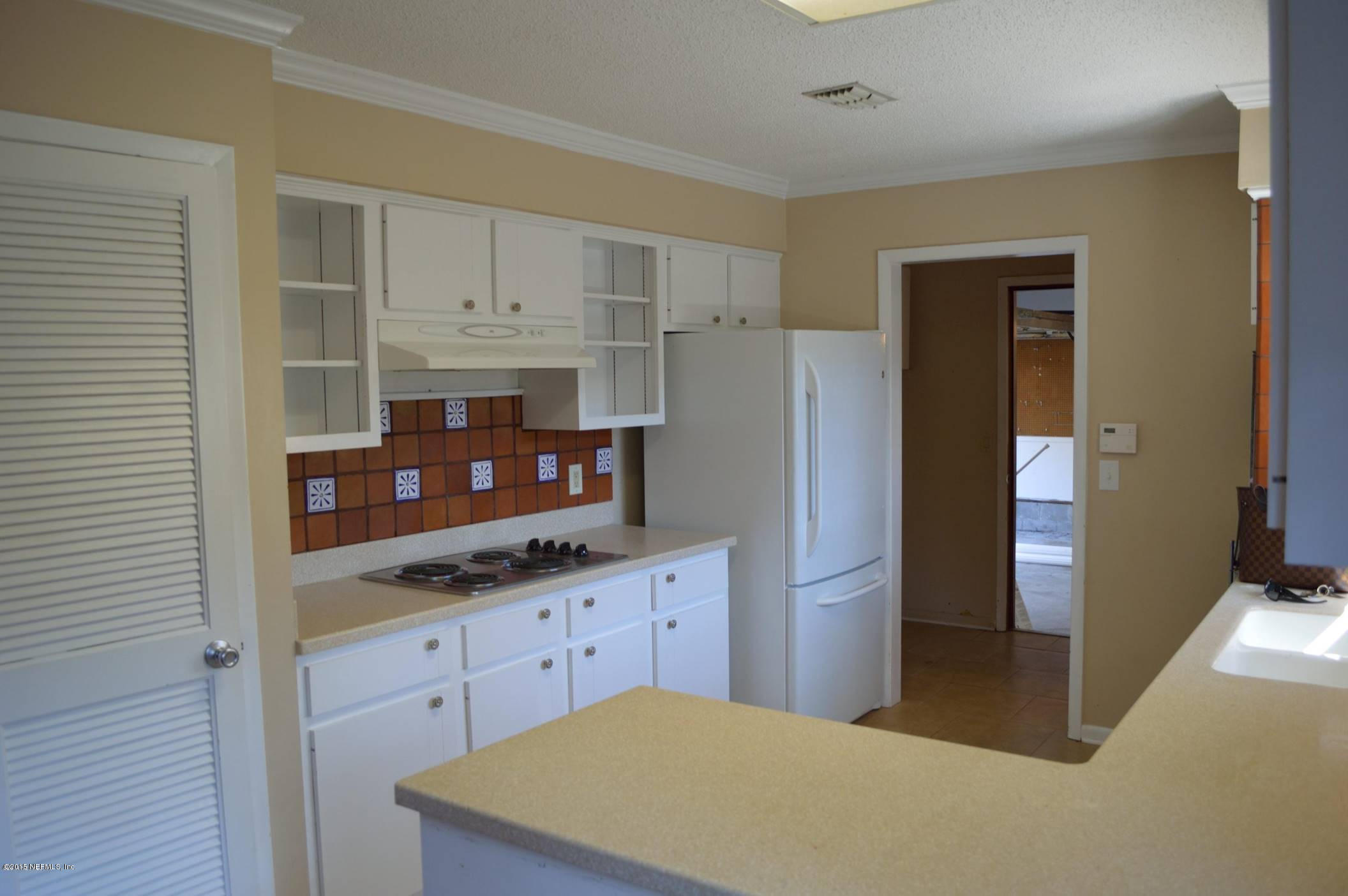 11468 Scott Mill Road Jacksonville, FL 32223 - Photo 10 of 25 a kitchen with stainless steel appliances a refrigerator and cabinets