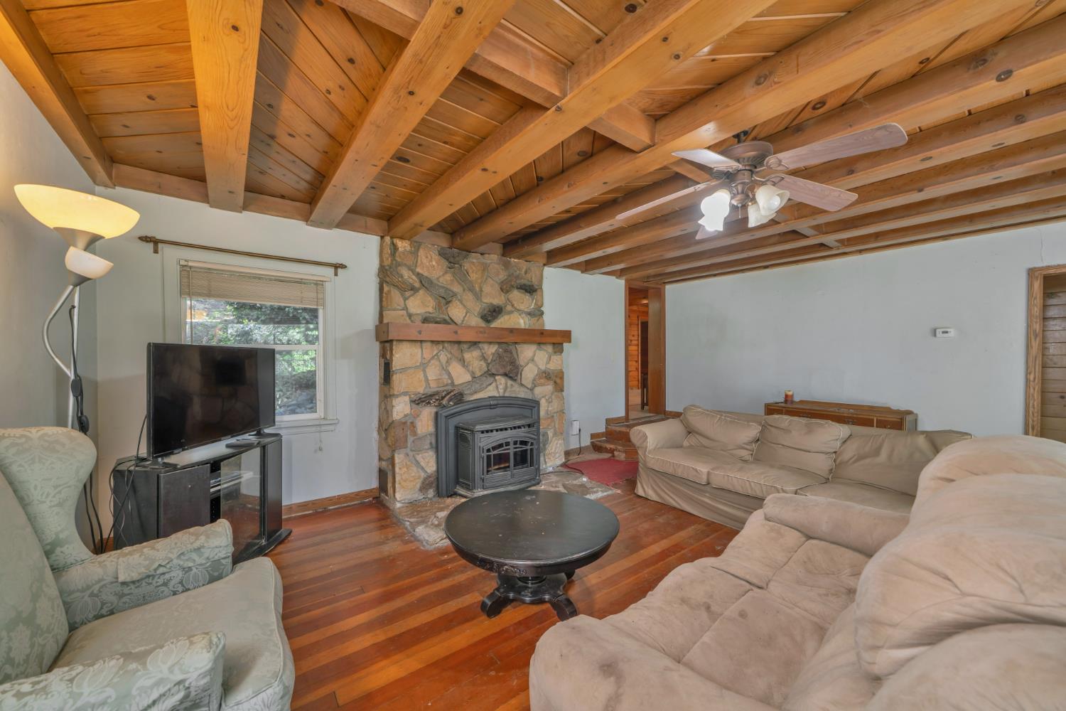 6929 Split Bend Road Pollock Pines, CA 95726 - Photo 22 of 38 a living room with furniture a fireplace and a flat screen tv