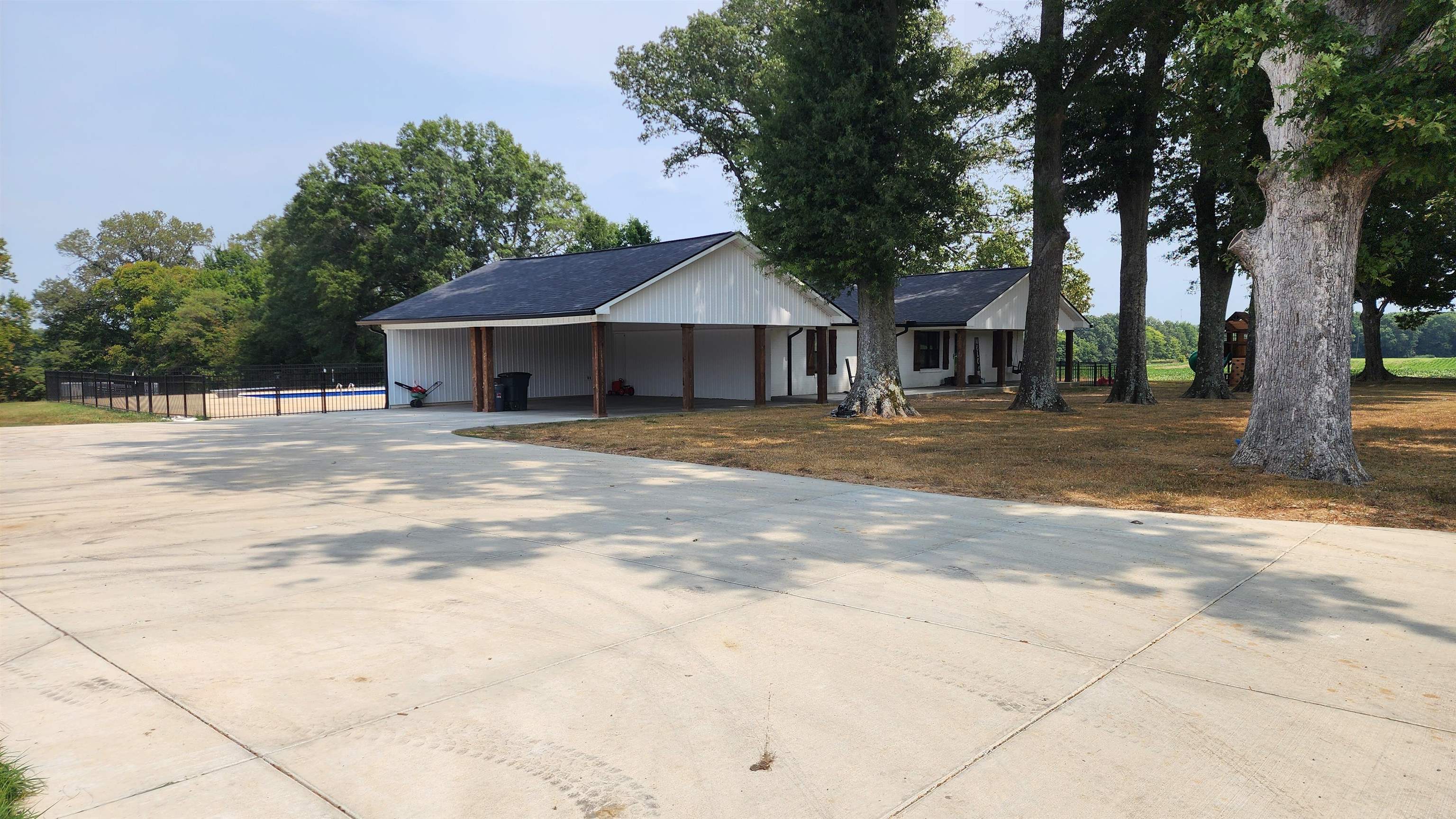 948 George Weakley Road Dyersburg, TN 38024 - Photo 2 of 31 a front view of a house with a yard and trees