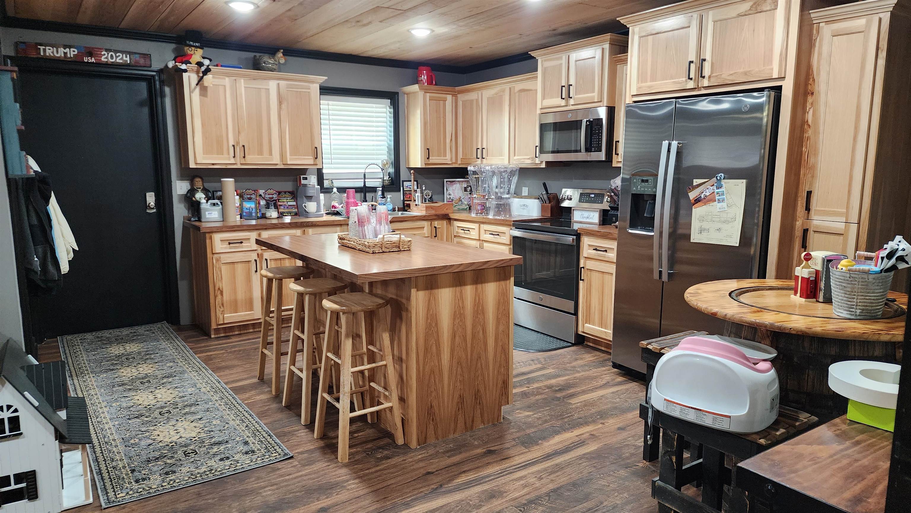 948 George Weakley Road Dyersburg, TN 38024 - Photo 21 of 31 a kitchen with stainless steel appliances granite countertop a stove a refrigerator a sink a dining table and chairs with wooden floor