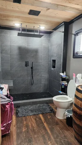 a bathroom with a toilet and shower