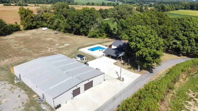 an aerial view of a house with a yard and lake view