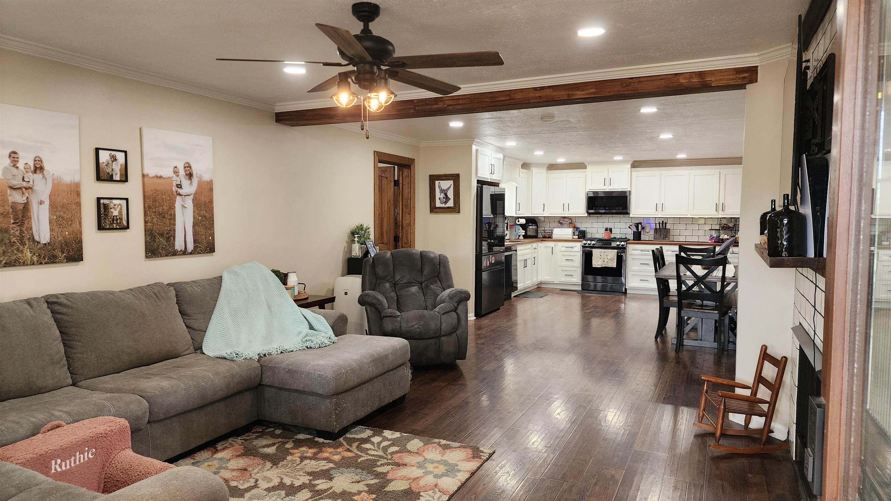 948 George Weakley Road Dyersburg, TN 38024 - Photo 3 of 31 a living room with furniture kitchen view and a wooden floor
