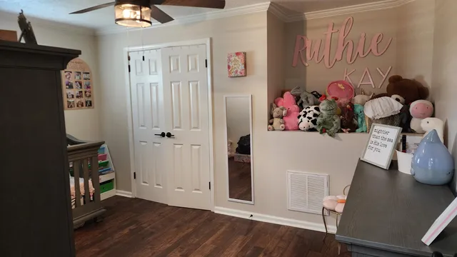 a view of a hallway with wooden floor and closet