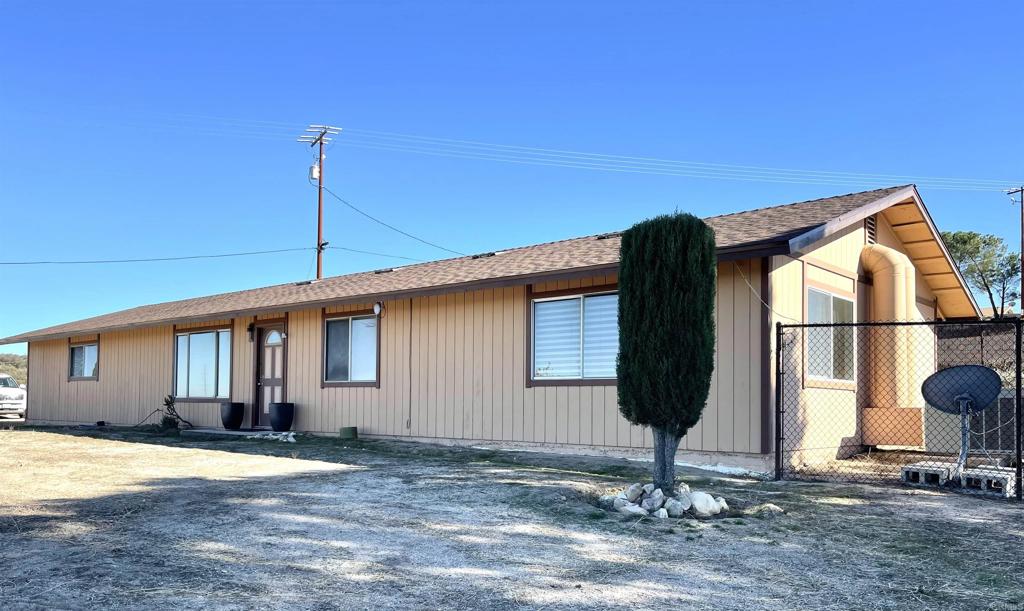 a front view of a house with basket ball court and potted plants