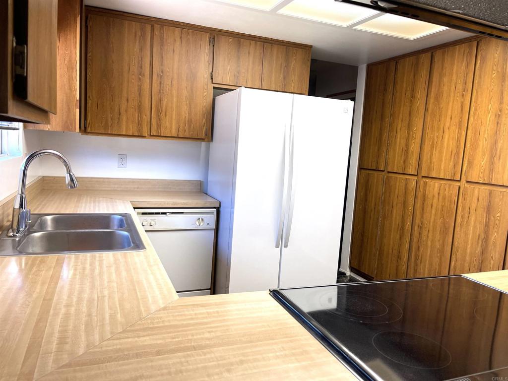 1902 Tierra Del Sol Road Boulevard, CA 91905 - Photo 11 of 37 a kitchen with a refrigerator and a sink