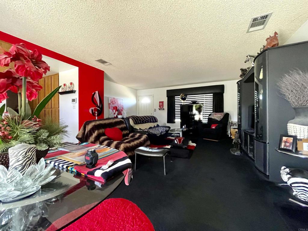 1902 Tierra Del Sol Road Boulevard, CA 91905 - Photo 16 of 37 a bedroom with furniture and a floor to ceiling window