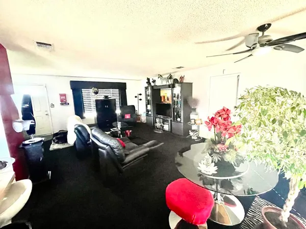 a living room with furniture and a floor to ceiling window
