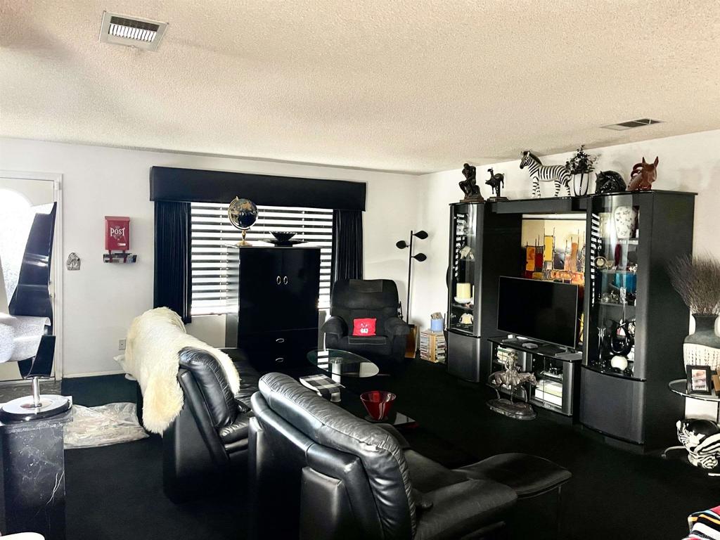 1902 Tierra Del Sol Road Boulevard, CA 91905 - Photo 23 of 37 a living room with furniture and a flat screen tv