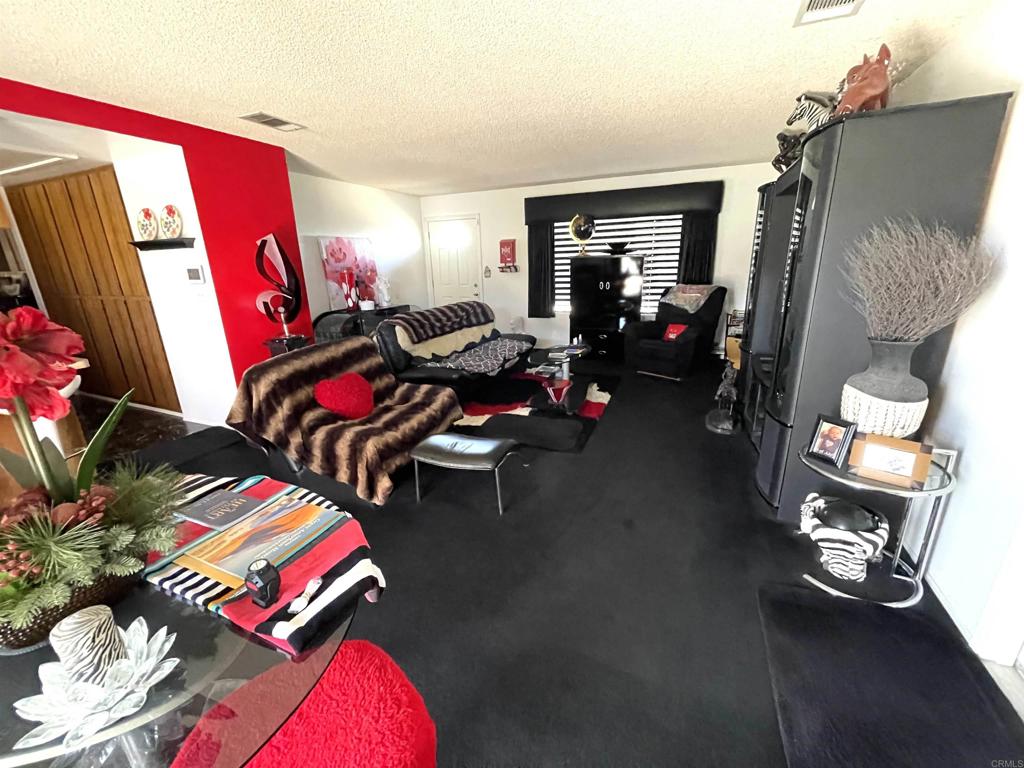 1902 Tierra Del Sol Road Boulevard, CA 91905 - Photo 26 of 37 a living room with furniture a bed and a couch