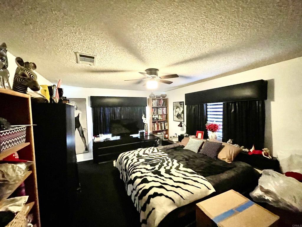 1902 Tierra Del Sol Road Boulevard, CA 91905 - Photo 27 of 37 a bedroom with furniture and a flat screen tv