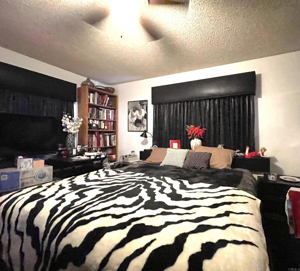 1902 Tierra Del Sol Road Boulevard, CA 91905 - Photo 28 of 37 a bedroom with a bed and a chandelier