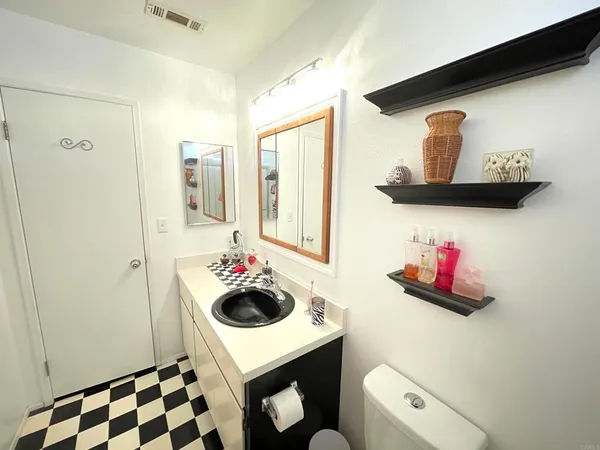 a bathroom with a sink vanity mirror and vanity