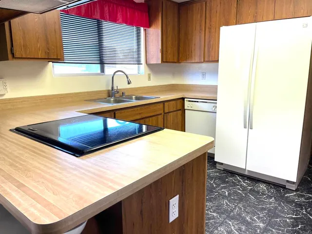 a kitchen with a sink and a refrigerator