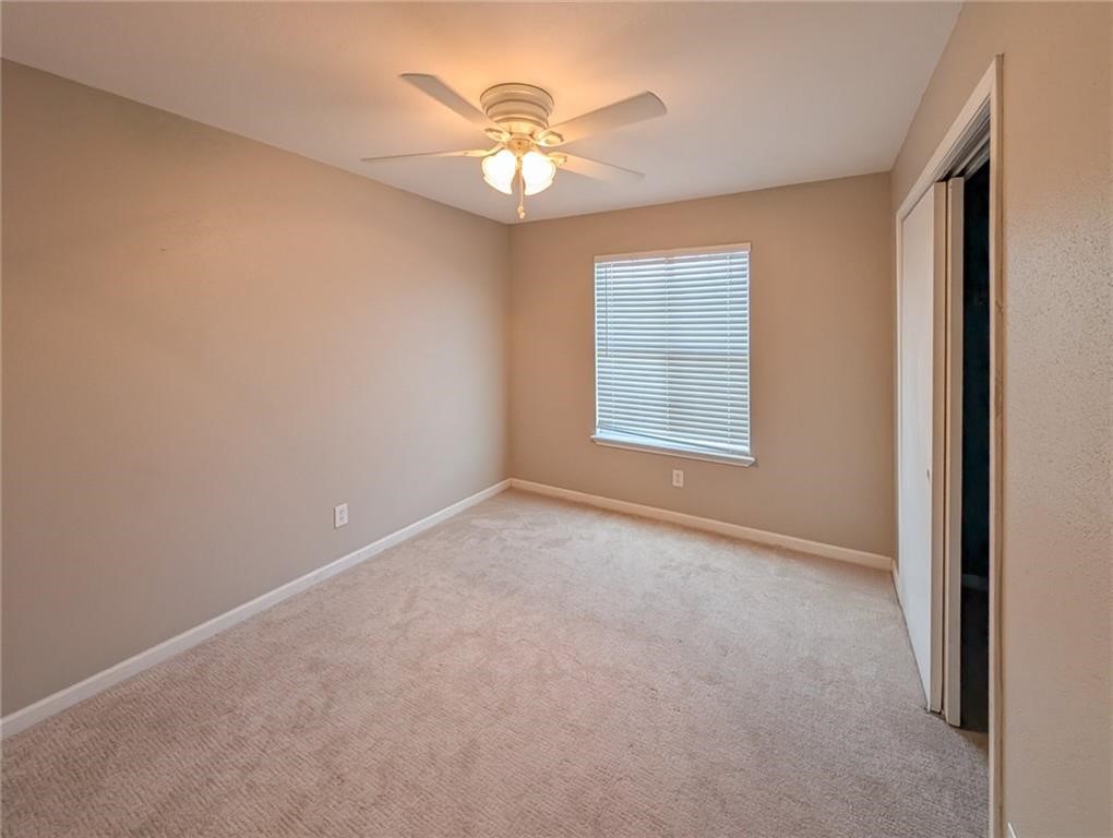 6702 Everhart Road, Unit S104 Corpus Christi, TX 78413 - Photo 17 of 22 an empty room with windows and chandelier fan