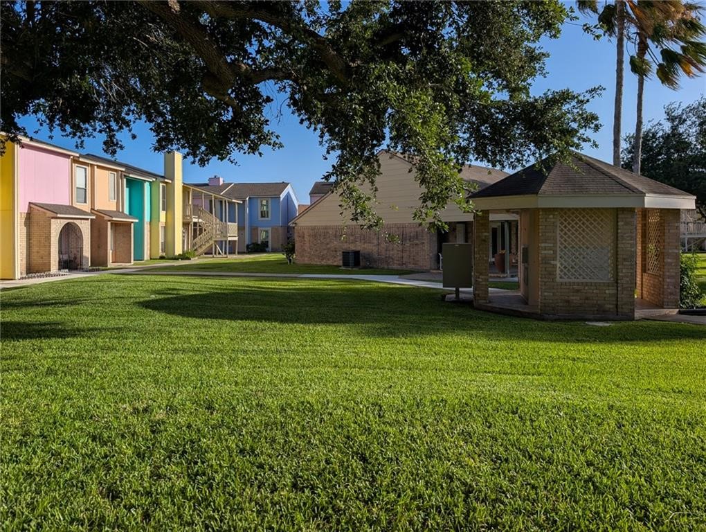 6702 Everhart Road, Unit S104 Corpus Christi, TX 78413 - Photo 20 of 22 a front view of a house with a garden