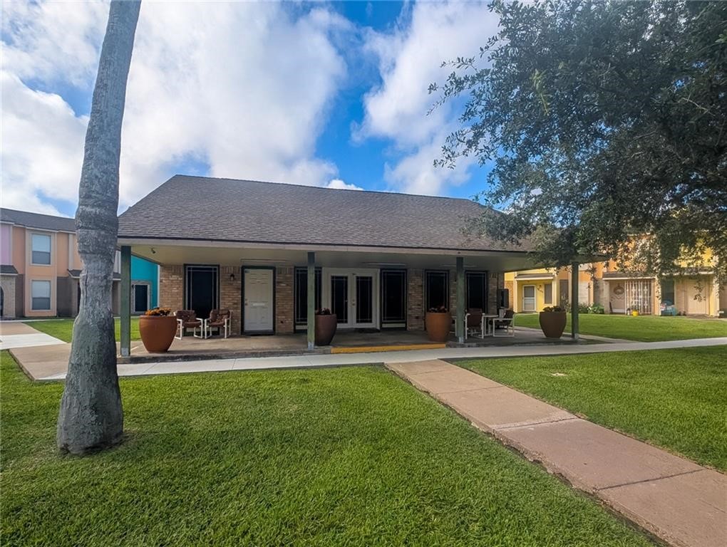 6702 Everhart Road, Unit S104 Corpus Christi, TX 78413 - Photo 22 of 22 a front view of a house with garden and trees