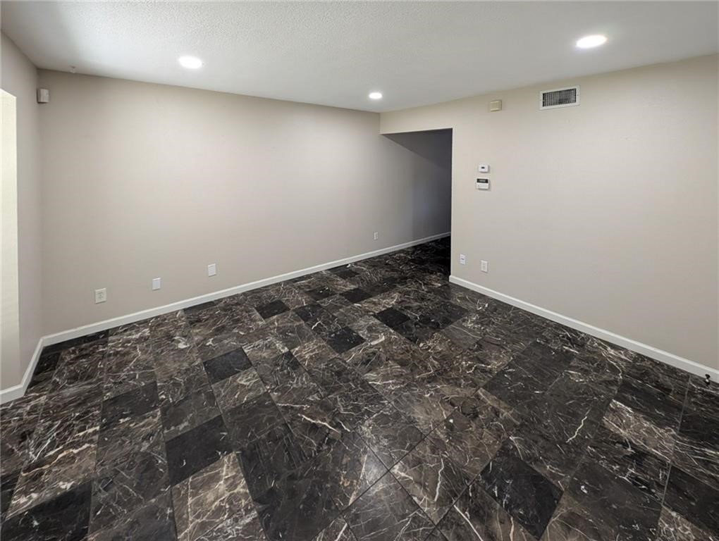 6702 Everhart Road, Unit S104 Corpus Christi, TX 78413 - Photo 8 of 22 an empty room with a natural light