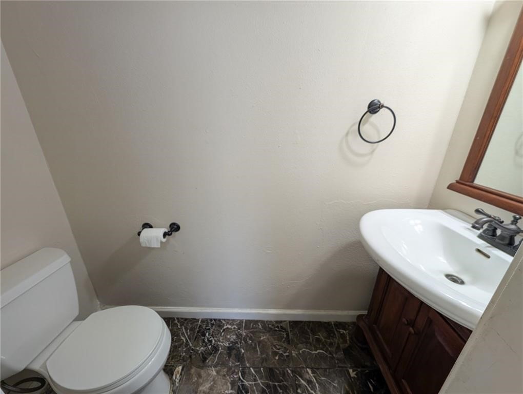 6702 Everhart Road, Unit S104 Corpus Christi, TX 78413 - Photo 10 of 22 a bathroom with a sink toilet and mirror