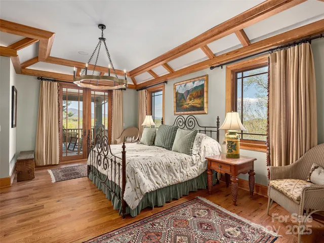 a bedroom with a large bed and a chandelier