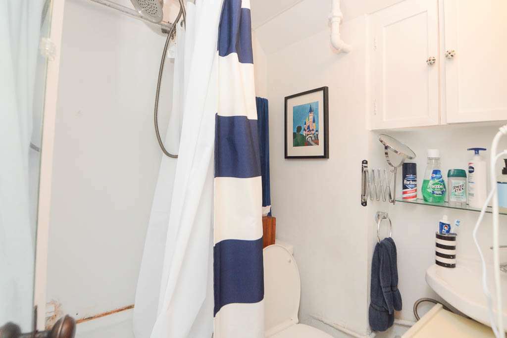1721 West Nelson Street, Unit CH3 Chicago, IL 60657 - Photo 18 of 20 a bathroom with a toilet and a shower curtain