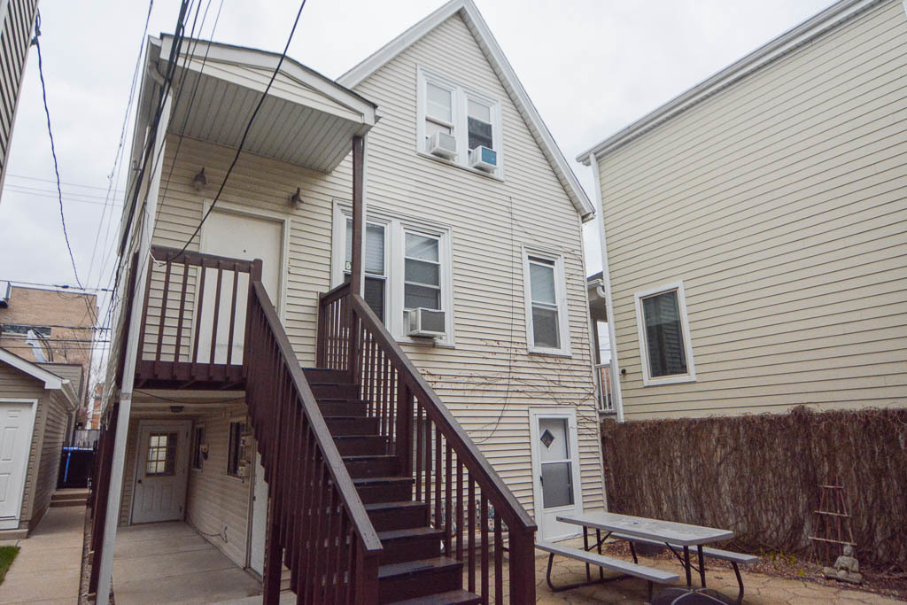 1721 West Nelson Street, Unit CH3 Chicago, IL 60657 - Photo 2 of 20 a view of deck with chairs and wooden fence