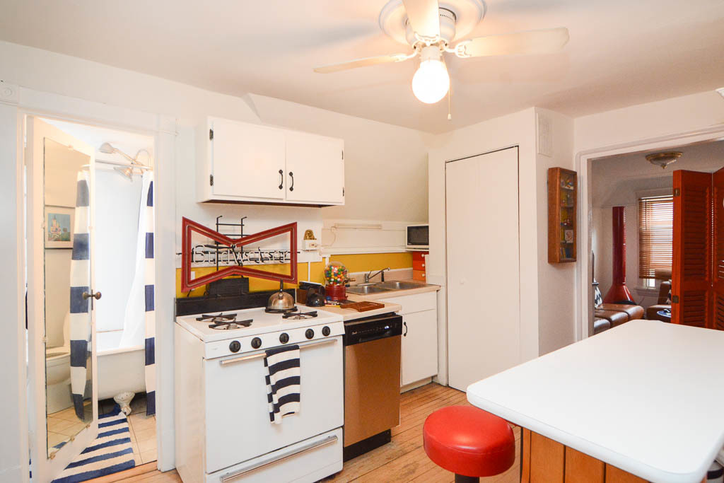 1721 West Nelson Street, Unit CH3 Chicago, IL 60657 - Photo 3 of 20 a kitchen with stainless steel appliances a stove a refrigerator a sink with white cabinets and wooden floor