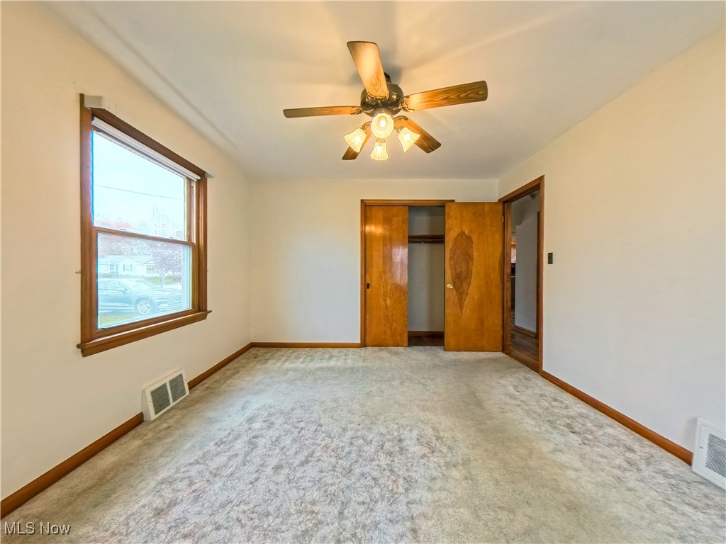 1668 Harwich Road Cleveland, OH 44124 - Photo 9 of 19 Unfurnished bedroom with a closet, carpet flooring, and ceiling fan