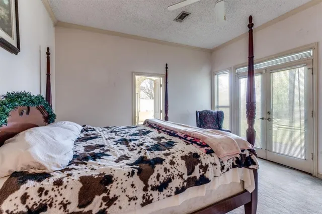 a bedroom with a large bed and a window