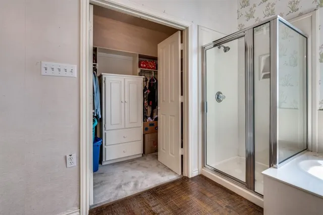 a view of a bathroom with a glass door shower