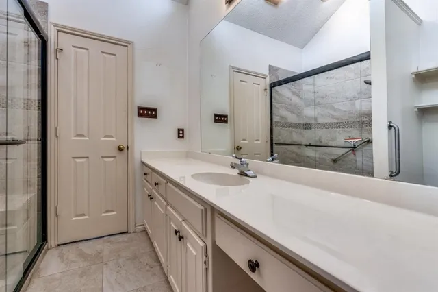 a bathroom with a double vanity sink and mirror