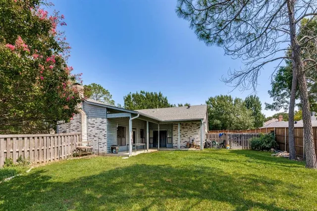 a view of a house with a yard and porch