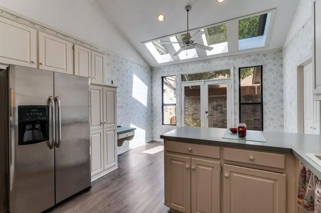 a kitchen with stainless steel appliances granite countertop a refrigerator and a sink