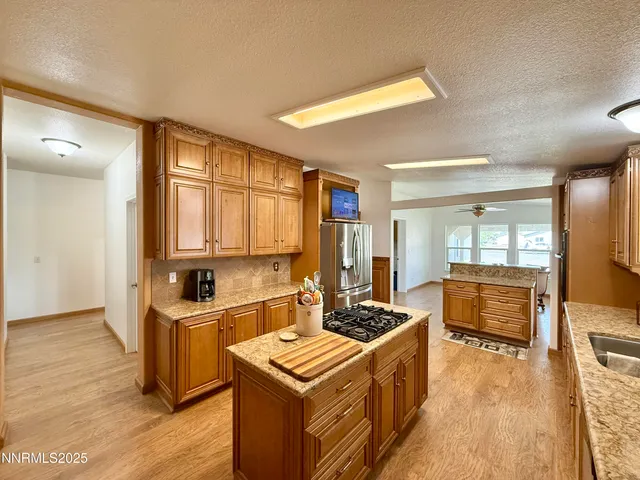 a kitchen that has a sink and a stove in it