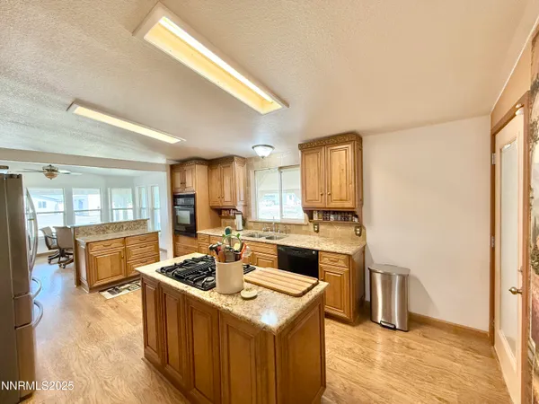 a kitchen with a stove a sink and a refrigerator
