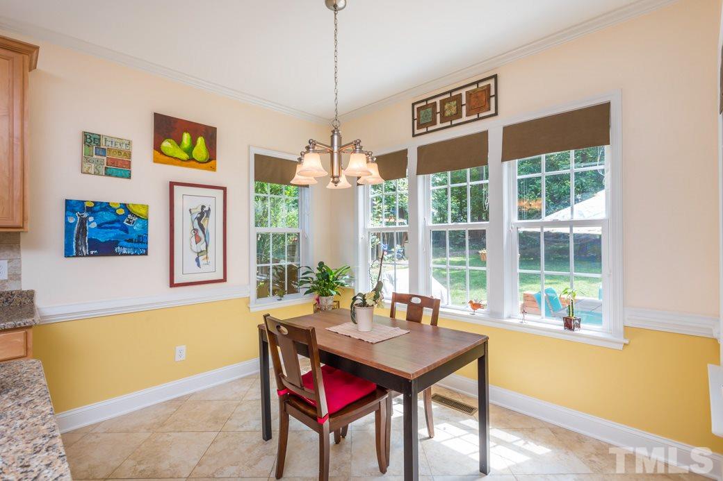 7604 Rambeau Circle Raleigh, NC 27613 - Photo 11 of 25 a view of a dining room with furniture window and outside view