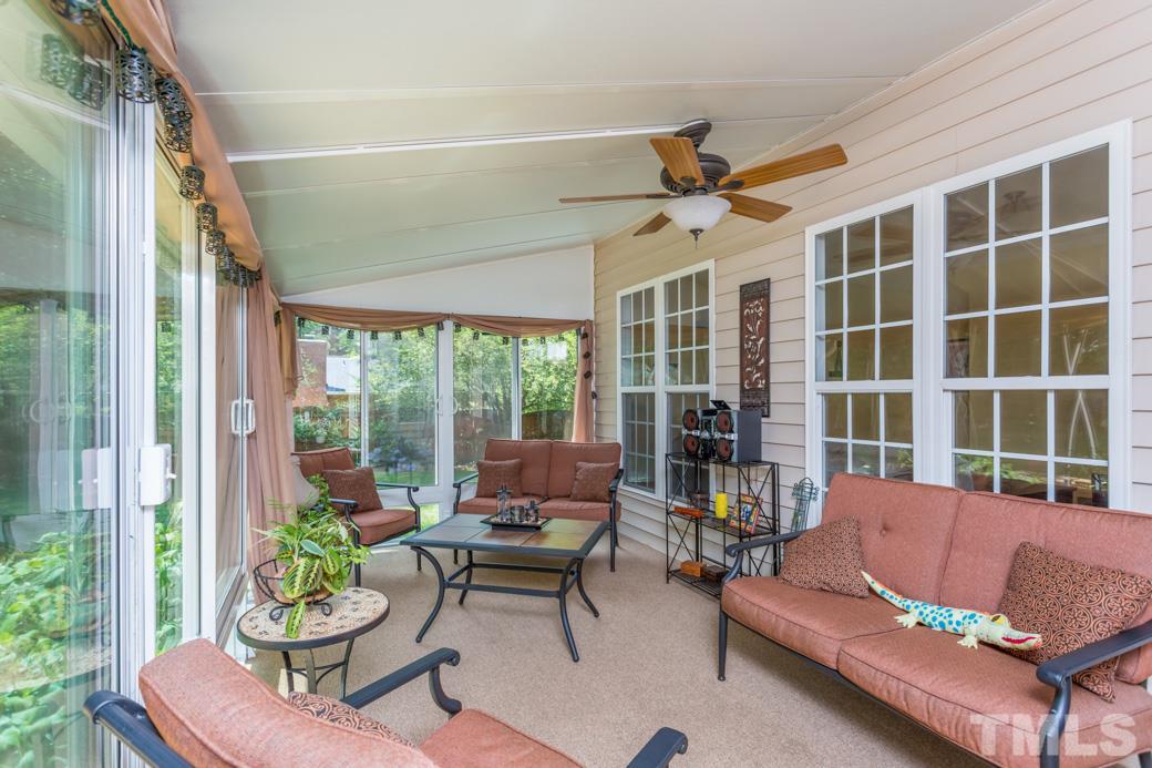 7604 Rambeau Circle Raleigh, NC 27613 - Photo 14 of 25 a living room with furniture and a large window