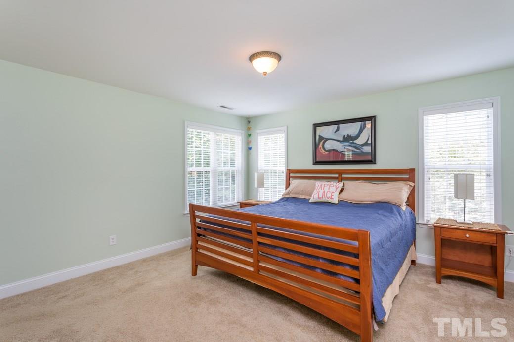 7604 Rambeau Circle Raleigh, NC 27613 - Photo 16 of 25 a bedroom with a bed and a window