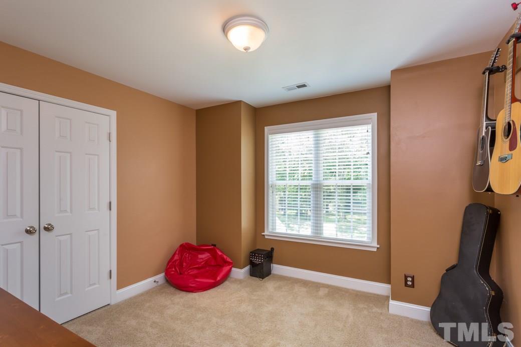 7604 Rambeau Circle Raleigh, NC 27613 - Photo 17 of 25 a bedroom with a bed and window