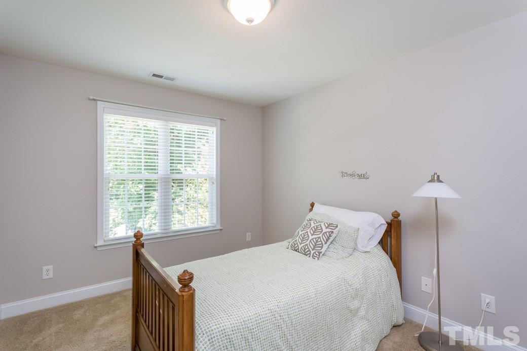 7604 Rambeau Circle Raleigh, NC 27613 - Photo 18 of 25 a bedroom with a bed and a window