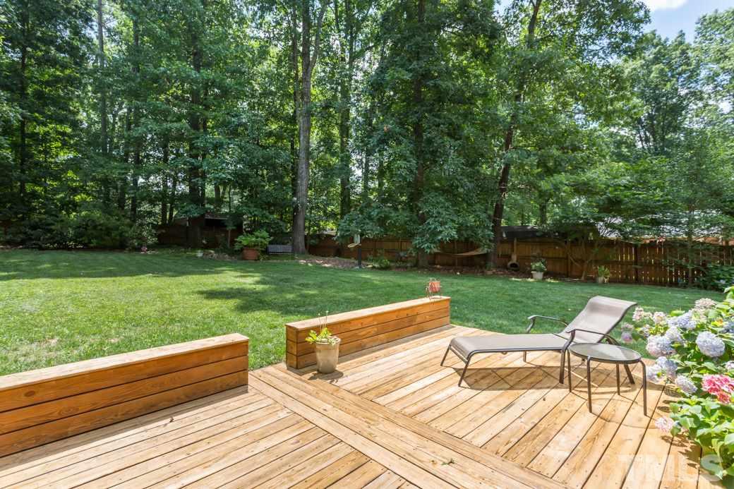 7604 Rambeau Circle Raleigh, NC 27613 - Photo 20 of 25 a view of a yard with a bench and trees