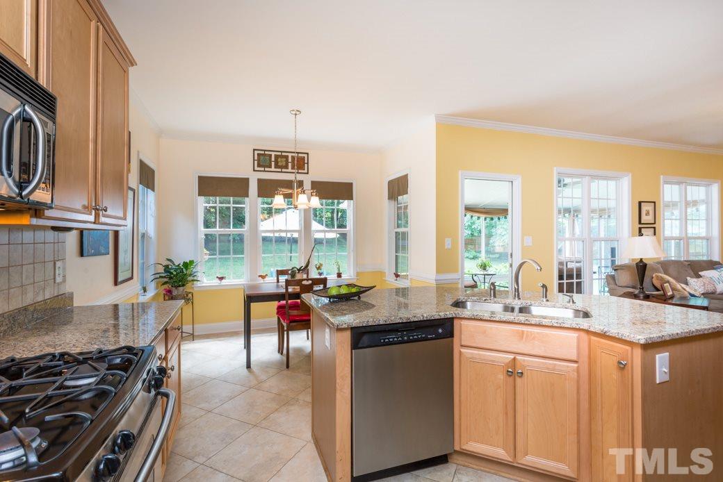 7604 Rambeau Circle Raleigh, NC 27613 - Photo 8 of 25 a kitchen with stainless steel appliances granite countertop a sink stove and cabinets